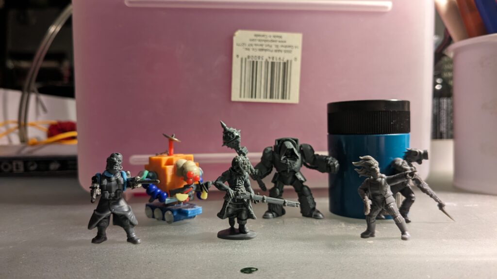 An image of six scratch built sci-fi miniatures.